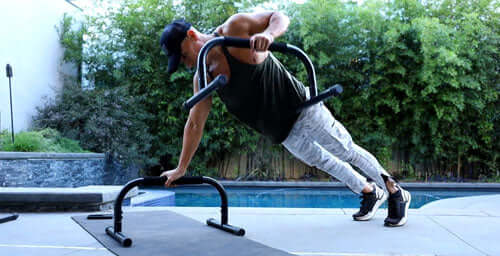 man working out using Lebert Fitness paralette bars